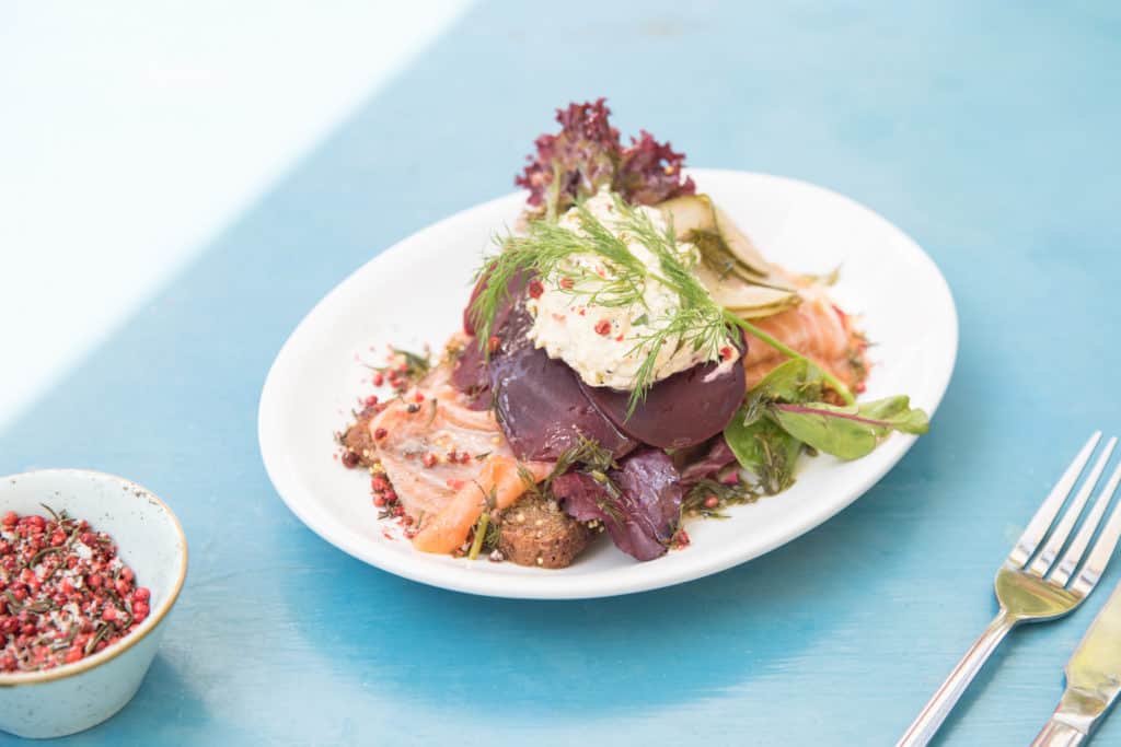 A bright plated vegetable salad on a pale blue tabletop