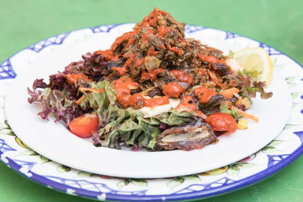 A plated fish salad with greens